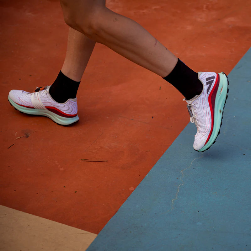 Person running in VJ Lightspeed lightweight trail shoes featuring amazing grip and high performance.