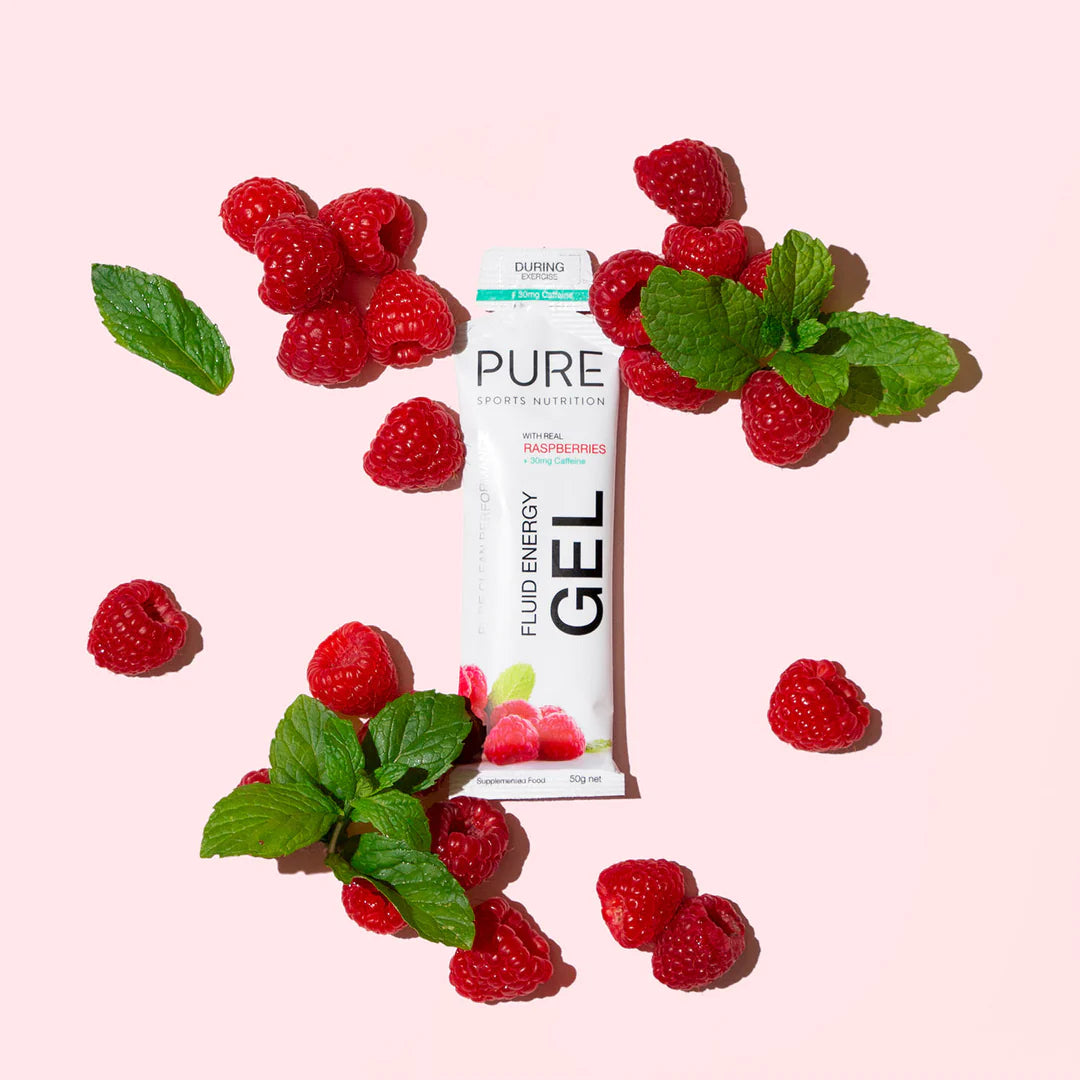 Pink background with product surrounded by raspberries