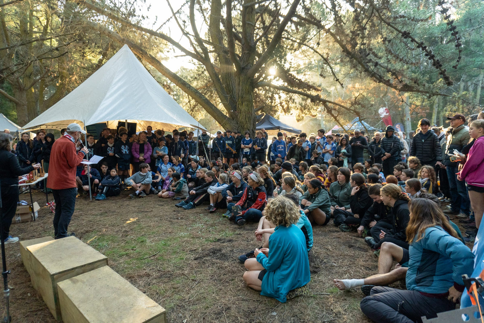 Students gathered under the pines for a prize-giving at the NZ Secondary Schools Orienteering Championships