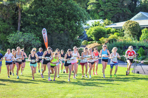 Photo showing women running from start line with map.