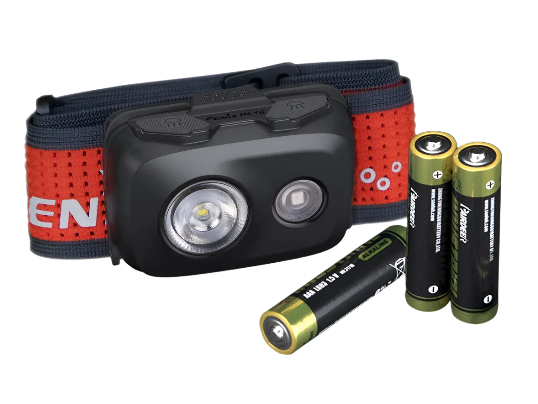 Secondary image of head torch showing small black box with two bulbs, red strap and also shows included 3x AAA batteries