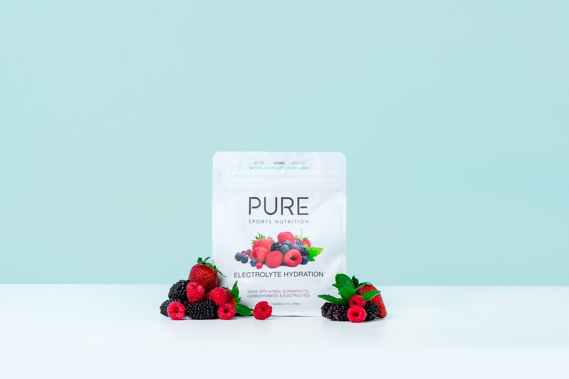 Product surrounded by berries on a teal background