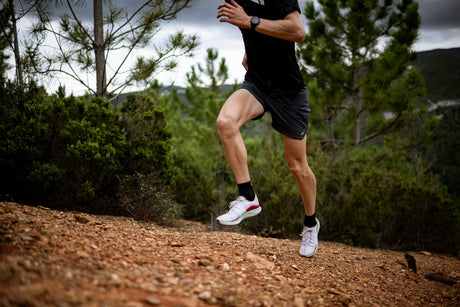 A trail runner on a dry hillside track